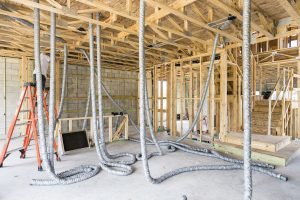 Worker installing duct runs