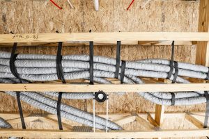 Duct strapping in floor system