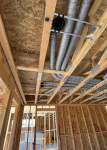 Ducts running in open web truss bay