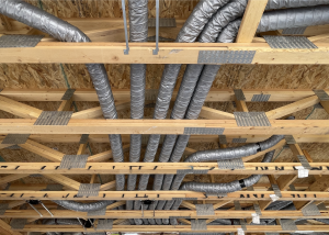 Ducts running through open web trusses