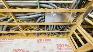 Open web truss duct runs and downflow manifold