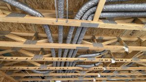 Running ducts in open web trusses