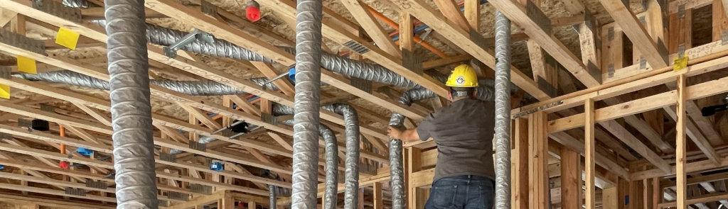 Installer feeding duct through framing